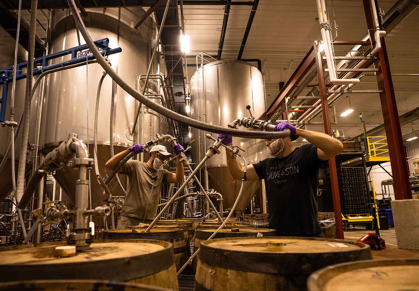 Image of interior of barrel house with two founders employees