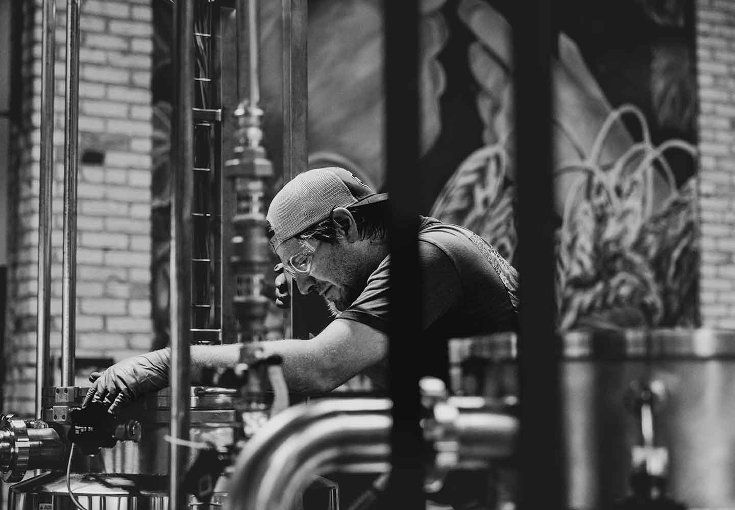 Black and white image of brewer in brewery